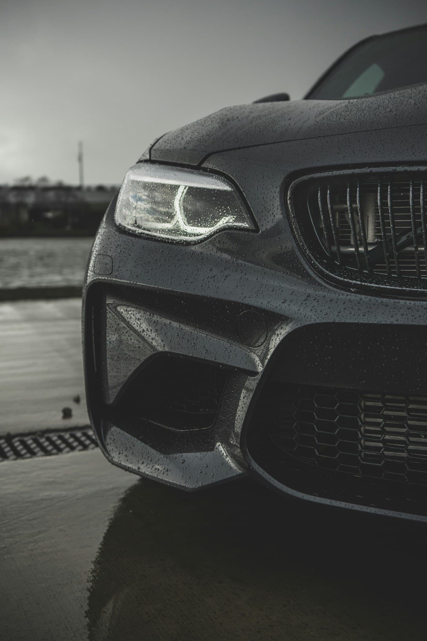 Close-up of a rain-covered BMW front end