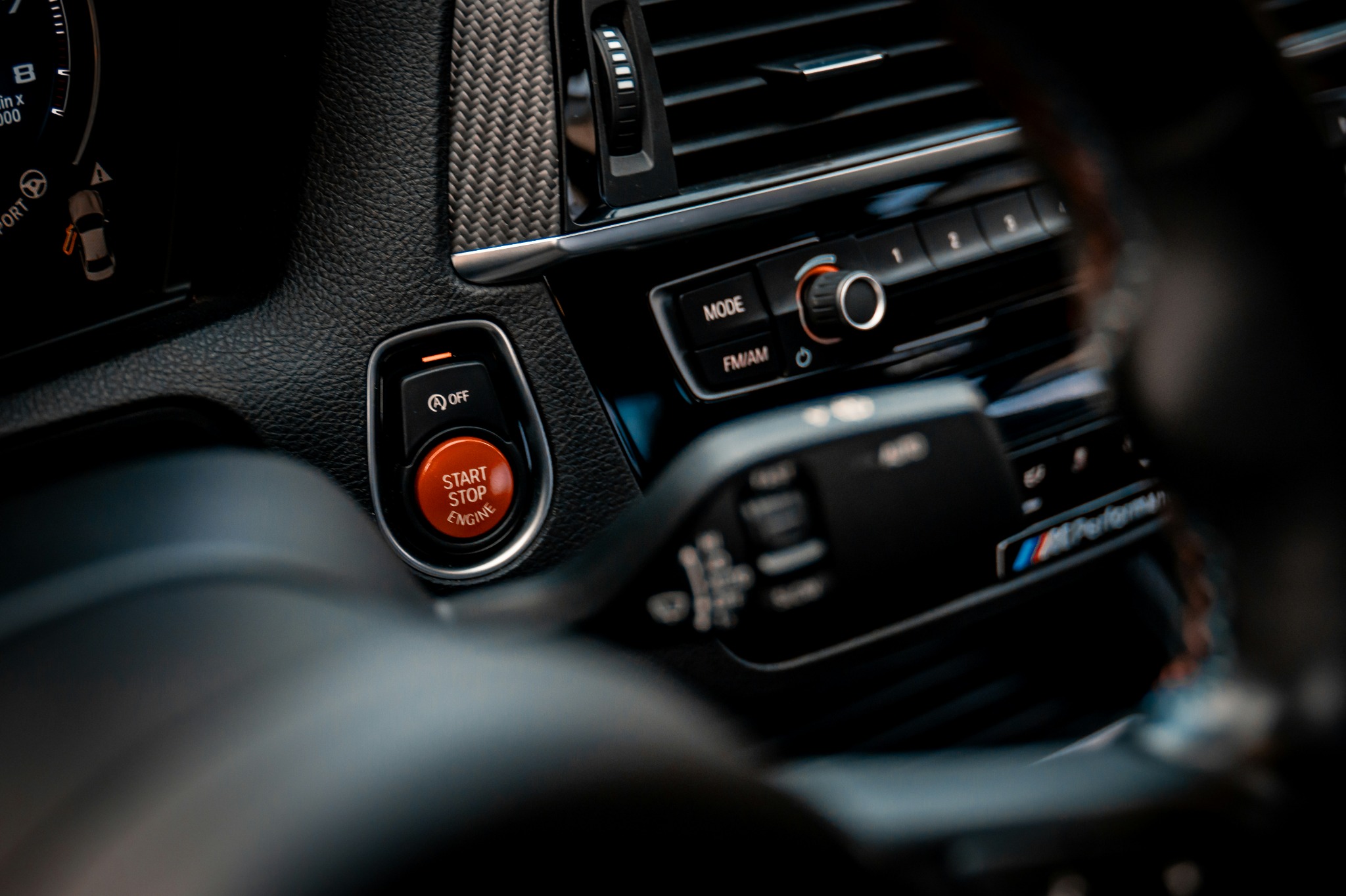 Premium vehicle interior with illuminated engine start button